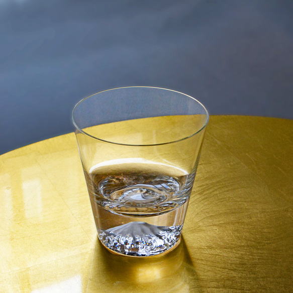 A clear glass with a sculpted Mt. Fuji design at the bottom, presented inside a wooden box. – view 2