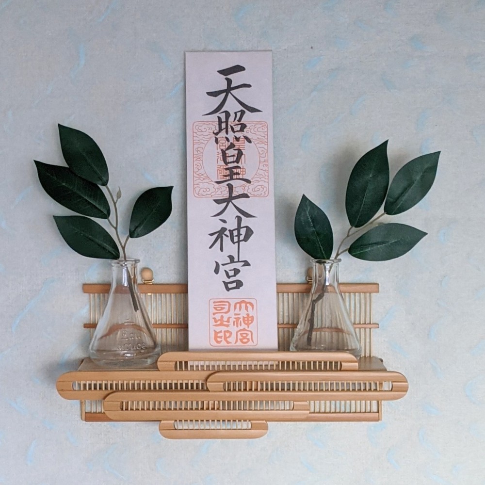 Compact modern wall-mounted Kamidana made of delicate vertical bamboo sticks and a cedar base, featuring a carved bamboo cloud motif.
