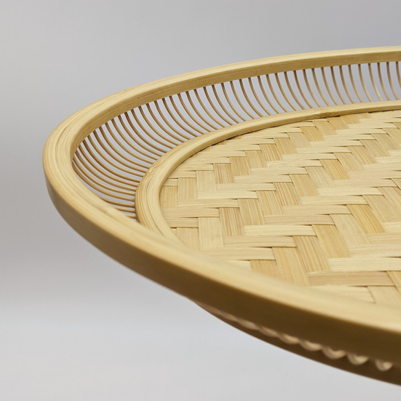 A hand-woven oval bamboo serving tray in natural beige, displaying traditional Japanese ajiro wickerwork on the base and smooth rounded bamboo curves. – view 4