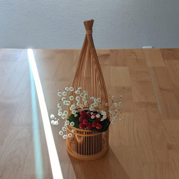 Handmade Suruga bamboo flower vase shaped like bundled straw, standing elegantly with its detailed patterns on its woven base – view 6