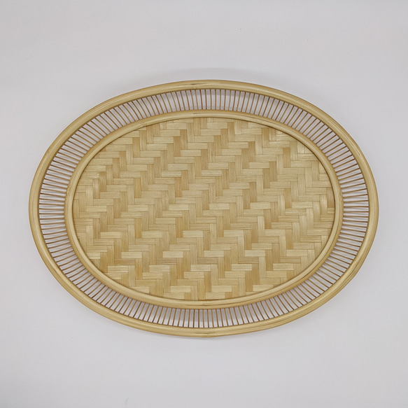 A hand-woven oval bamboo serving tray in natural beige, displaying traditional Japanese ajiro wickerwork on the base and smooth rounded bamboo curves. – view 7
