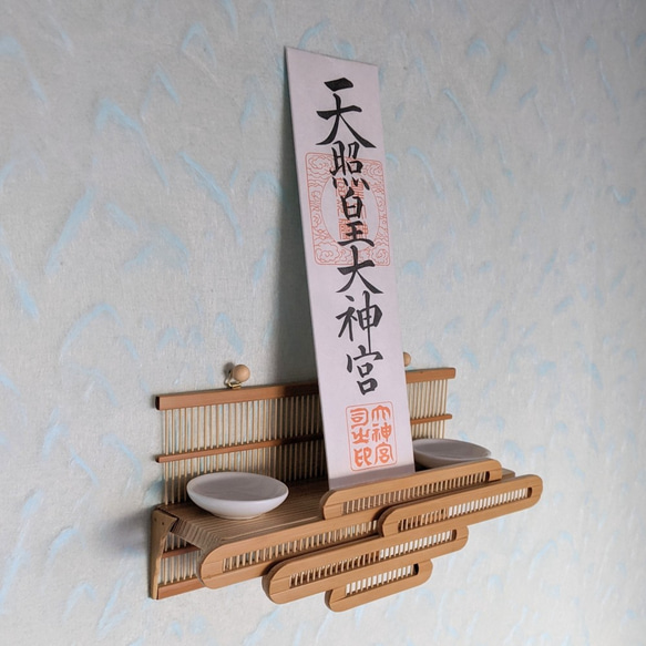 Compact modern wall-mounted Kamidana made of delicate vertical bamboo sticks and a cedar base, featuring a carved bamboo cloud motif. – view 4