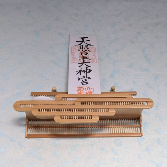 Compact modern wall-mounted Kamidana made of delicate vertical bamboo sticks and a cedar base, featuring a carved bamboo cloud motif. – view 5