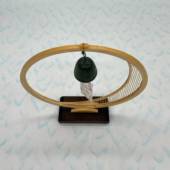 A delicate tabletop wind chime featuring a crescent moon-shaped Suruga bamboo frame holding a small dark Nambu cast iron bell – view 4