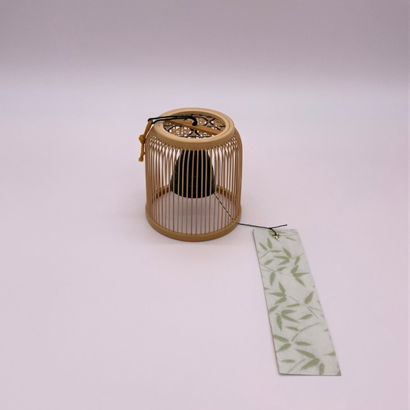 A delicately woven Suruga bamboo wind chime dome inspired by a Komuso monk's basket hat, containing a black Nambu iron bell. – view 4