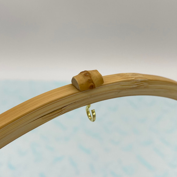A delicate tabletop wind chime featuring a crescent moon-shaped Suruga bamboo frame holding a small dark Nambu cast iron bell – view 5