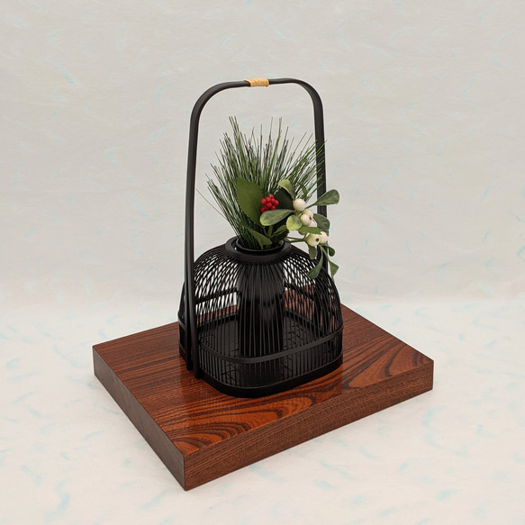 An elegant black Suruga bamboo flower vase with a rattan-wrapped handle, showcasing intricate vertical bamboo lattice work. – view 2