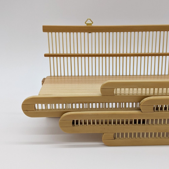 Compact modern wall-mounted Kamidana made of delicate vertical bamboo sticks and a cedar base, featuring a carved bamboo cloud motif. – view 7
