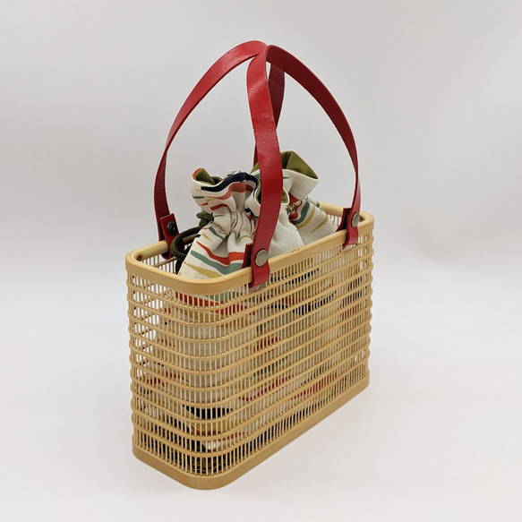 A rectangular hand-woven Suruga bamboo basket bag with a red leather handle and a vintage white silk drawstring inner pouch featuring a mist pattern – view 3