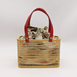 A rectangular hand-woven Suruga bamboo basket bag with a red leather handle and a vintage white silk drawstring inner pouch featuring a mist pattern