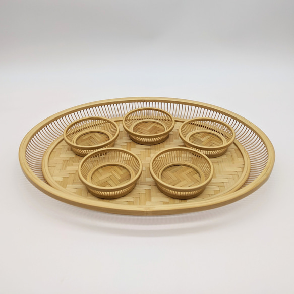 A hand-woven oval bamboo serving tray in natural beige, displaying traditional Japanese ajiro wickerwork on the base and smooth rounded bamboo curves. – view 8