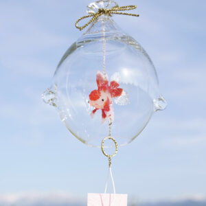 Handmade glass wind chime shaped like a water bag containing a red and white Oranda goldfish, designed to hang and sway in the breeze.