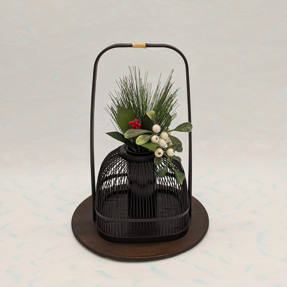 An elegant black Suruga bamboo flower vase with a rattan-wrapped handle, showcasing intricate vertical bamboo lattice work. – view 3