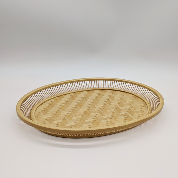 A hand-woven oval bamboo serving tray in natural beige, displaying traditional Japanese ajiro wickerwork on the base and smooth rounded bamboo curves. – view 6