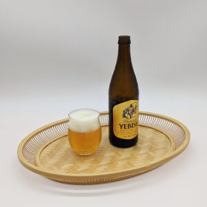 A hand-woven oval bamboo serving tray in natural beige, displaying traditional Japanese ajiro wickerwork on the base and smooth rounded bamboo curves.
