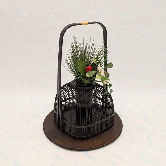 An elegant black Suruga bamboo flower vase with a rattan-wrapped handle, showcasing intricate vertical bamboo lattice work. – view 4