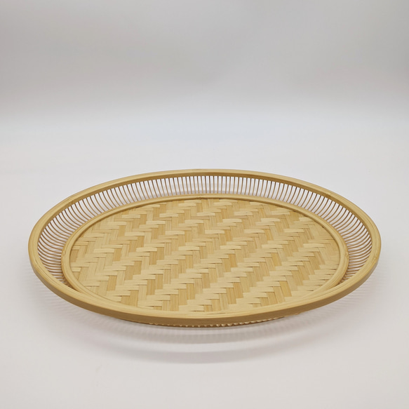 A hand-woven oval bamboo serving tray in natural beige, displaying traditional Japanese ajiro wickerwork on the base and smooth rounded bamboo curves. – view 3