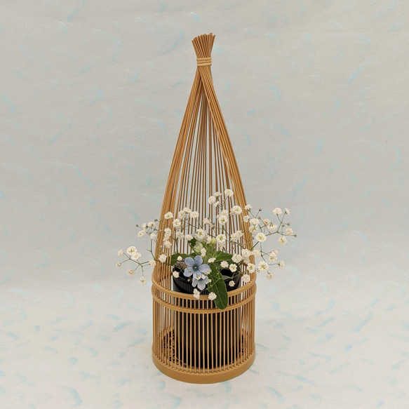 Handmade Suruga bamboo flower vase shaped like bundled straw, standing elegantly with its detailed patterns on its woven base – view 5